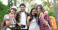Asian Group of young people with friends backpacks walking together and happy friends are raised arms and enjoying a beautiful Royalty Free Stock Photo