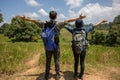 Asian Group of young people with friends backpacks walking together and happy friends are raised arms and enjoying a beautiful Royalty Free Stock Photo