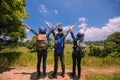 Asian Group of young people with friends backpacks walking together and happy friends are raised arms and enjoying a beautiful Royalty Free Stock Photo