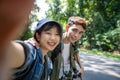 Asian Group of young people with friends and backpacks walking together and happy friends are taking photo and selfie ,Relax time Royalty Free Stock Photo