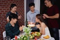 Asian groups Celebrating at a birthday party. She is blowing candles Royalty Free Stock Photo