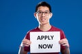 Asian guy asking you to apply now Royalty Free Stock Photo