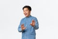 Asian guy feeling awkward, apologizing and step back, raising hands up in stop gesture, politely rejecting offer, saying