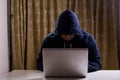 Asian hacker hacking computer network with laptop Royalty Free Stock Photo