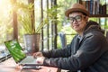 Asian Hacker using laptop and computers in cafe. Royalty Free Stock Photo