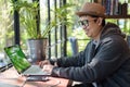 Asian Hacker using laptop and computers in cafe. Royalty Free Stock Photo