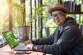 Asian Hacker using laptop and computers in cafe. Royalty Free Stock Photo