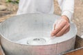 Asian hand rolling cotton candy with bamboo stick in floss machine in Vietnam