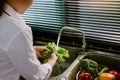 Asian hands woman washing vegetables salad and preparation healthy food in kitchen Royalty Free Stock Photo