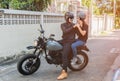 Asian handsome biker wearing helmet and wearing helmet to girlfriend Royalty Free Stock Photo