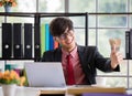 Asian handsome business working man wearing eyeglasses, red shirt with necktie, large smiling and making great thump up with Royalty Free Stock Photo