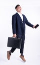 Asian handsome business working man wearing formal blue suit, holding black briefcase and mobile phone, jumping, shout out, Royalty Free Stock Photo