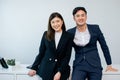 Asian handsome businessman and beautiful smart intelligent businesswoman wearing formal suits, working, smiling with success and Royalty Free Stock Photo