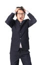 Asian handsome businessman holding his head frowning with worry. Royalty Free Stock Photo