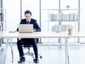 Asian handsome businessman in suit working with laptop computer on desk in office Royalty Free Stock Photo