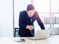 Asian handsome businessman in suit working with laptop computer on desk in office