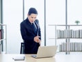 Asian handsome businessman in suit working with laptop computer on desk in office