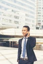 Asian handsome businessman using smart phone walking in the city Royalty Free Stock Photo