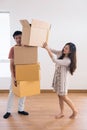 Asian handsome exhausted husband man carrying many stacked cardboard boxes