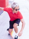 Asian handsome man surfing skateboard and abbreviate on skate board at skateboard street way in daylight time, summer holiday Royalty Free Stock Photo