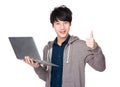 Asian handsome man use of laptop computer and thumb up