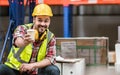 Asian handsome professional male worker smiling, holding cup of coffee, taking rest after work in storage, warehouse or factory Royalty Free Stock Photo