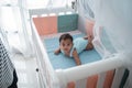 Asian happy baby on the crib Royalty Free Stock Photo