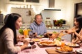 Asian happy big family enjoy spend time together celebrate Christmas party, eat foods and drink on dinner table at home. Loving Gr Royalty Free Stock Photo