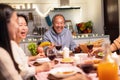 Asian happy big family enjoy spend time together celebrate Christmas party, eat foods and drink on dinner table at home. Loving Gr Royalty Free Stock Photo