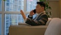 Asian happy businessman chinese japanese man calling mobile phone sit in office modern company smiling ethnic middle Royalty Free Stock Photo