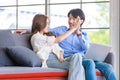 Asian happy cheerful joyful husband and wife lover couple family sitting smiling cuddling together on cozy sofa couch watching Royalty Free Stock Photo