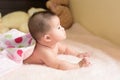 Asian happy child lay on bed. Royalty Free Stock Photo