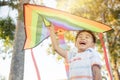 Asian happy children boy with a kite running to fly on in park Royalty Free Stock Photo