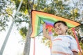 Asian happy children boy with a kite running to fly on in park Royalty Free Stock Photo