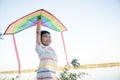 Asian happy children boy with a kite running to fly on in park Royalty Free Stock Photo