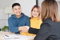 Asian happy couple getting key and handshake with realtor agent with smiling face at new home.buying new house real estate