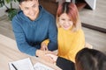 Asian happy couple getting key and handshake with realtor agent with smiling face at new home.buying new house real estate Royalty Free Stock Photo