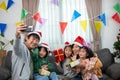 Asian Happy family with daughter in Santa hats gathered together and video call on Christmas time and enjoy gifts box