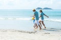 Asian happy family have fun and running relax on the beach for leisure and destination.  Family people tourism travel enjoy in sum Royalty Free Stock Photo