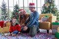 Asian happy family and little girl celebrating at Christmas Blowing the paper and gift box with Christmas tree in living room. My Royalty Free Stock Photo
