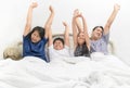 Asian Happy family waking up with raised hands