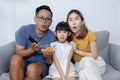 Asian Happy Family Watch Excited Movie on Sofa