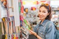 Happy girl shopping for kitchenware in retail store Royalty Free Stock Photo