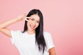 Asian happy portrait beautiful cute young woman teen smile standing showing finger making v-sign victory symbol near eye Royalty Free Stock Photo