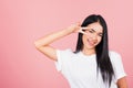 Asian happy portrait beautiful cute young woman teen smile standing showing finger making v-sign victory symbol near eye Royalty Free Stock Photo