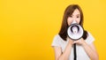 Woman teen standing making announcement message shouting screaming in megaphone