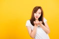 Woman teen standing wear t-shirt blowing kiss air something on hands Royalty Free Stock Photo