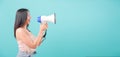 Woman standing smile her holding her Shouting through a megaphone message to something