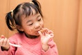 A happy toddler child eating chocolate ice cream in a cone with a messy face Royalty Free Stock Photo