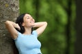 Asian happy woman relaxing leaning in tree in a park Royalty Free Stock Photo